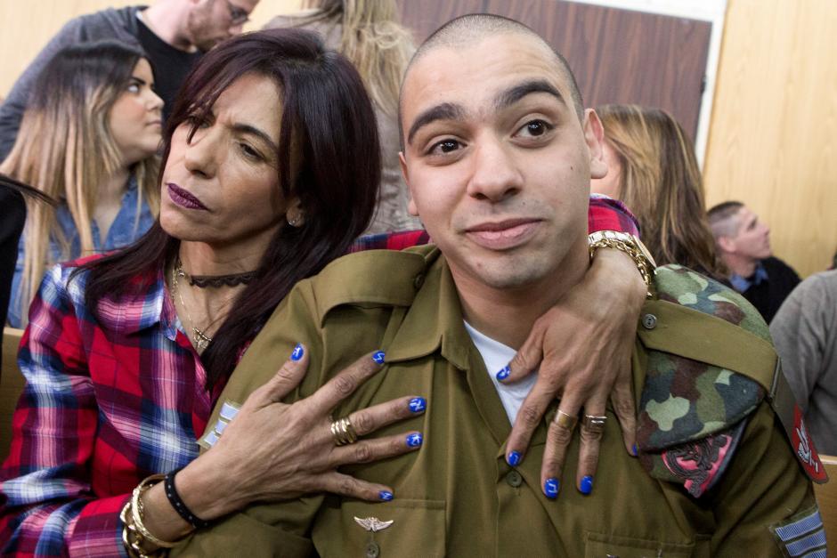 Israeli soldier Elor Azaria is embraced by his mother at the start of is sentencing hearing at a military court in Tel Aviv, Israel February 21, 2017. Reuters/Jim Hollander