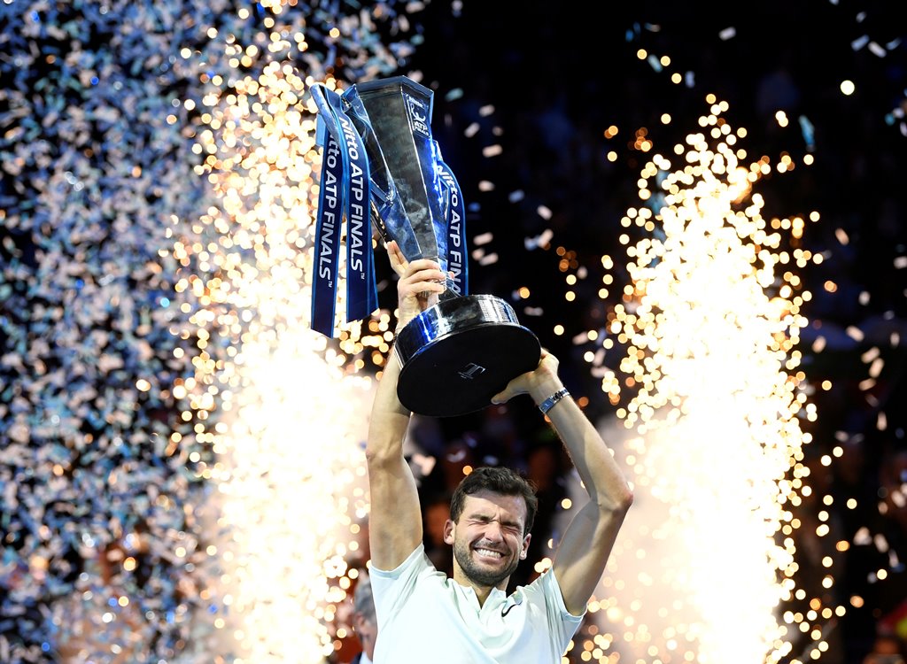 Tennis - ATP World Tour Finals - The O2 Arena, London, Britain - November 19, 2017 Bulgaria's Grigor Dimitrov celebrates with the trophy after winning the final against Belgium's David Goffin Action Images via Reuters/Tony O'Brien 