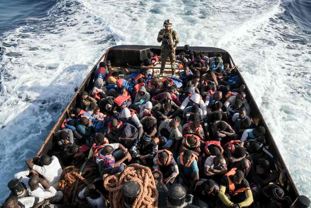A Libyan coast guardsman stands on a boat during the rescue of 147 illegal immigrants attempting to reach Europe off the coastal town of Zawiyah, 45 kilometres west of the capital Tripoli, on June 27, 2017.  AFP / Taha JAWASHI