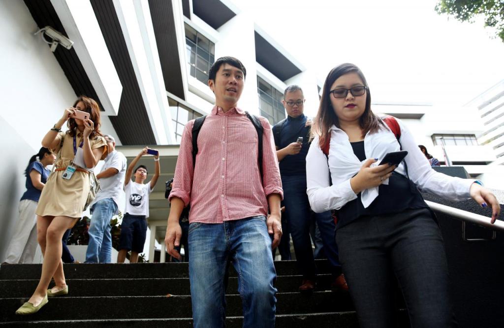 Civil rights activist Jolovan Wham (C) leaves the State Court after a hearing in Singapore November 29, 2017. REUTERS/Edgar Su.