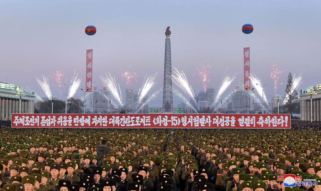 This December 1, 2017 picture released by North Korea's official Korean Central News Agency (KCNA) on December 2, 2017 shows North Korean soldiers and Pyongyang residents holding a rally to celebrate the North's declaration on November 29 it had achieved 