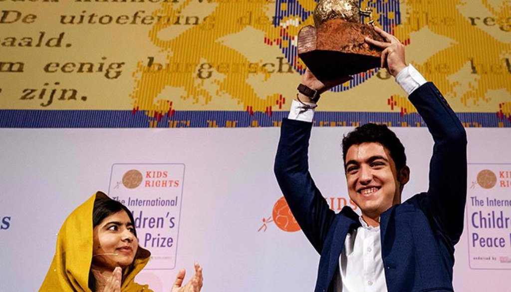 16-year old Syrian Mohamad Al Jounde (R) celebrates after receiving the International Children´s Peace Prize, given to him by Pakistani activist and Nobel Peace Prize laureate Malala Yousafzai on December 4, 2017 at the Ridderzaal in the Hague. Netherland