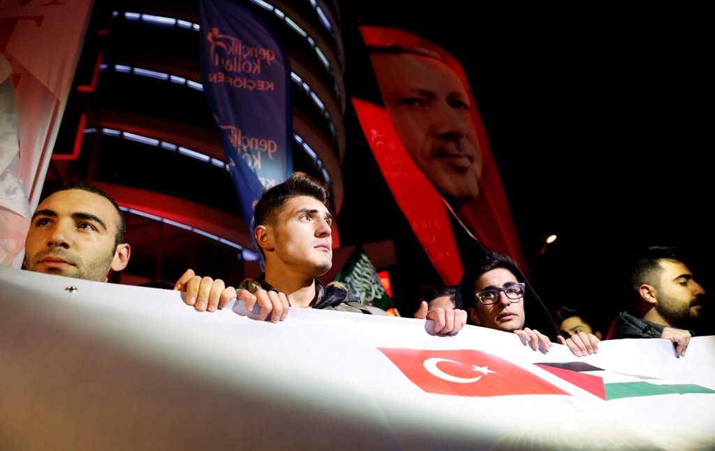 Demonstrators hold banners and a portrait of Turkey's President Tayyip Erdogan, during a protest against the U.S. intention to move its embassy to Jerusalem and to recognise the city of Jerusalem as the capital of Israel, near the U.S. Embassy in Ankara, 