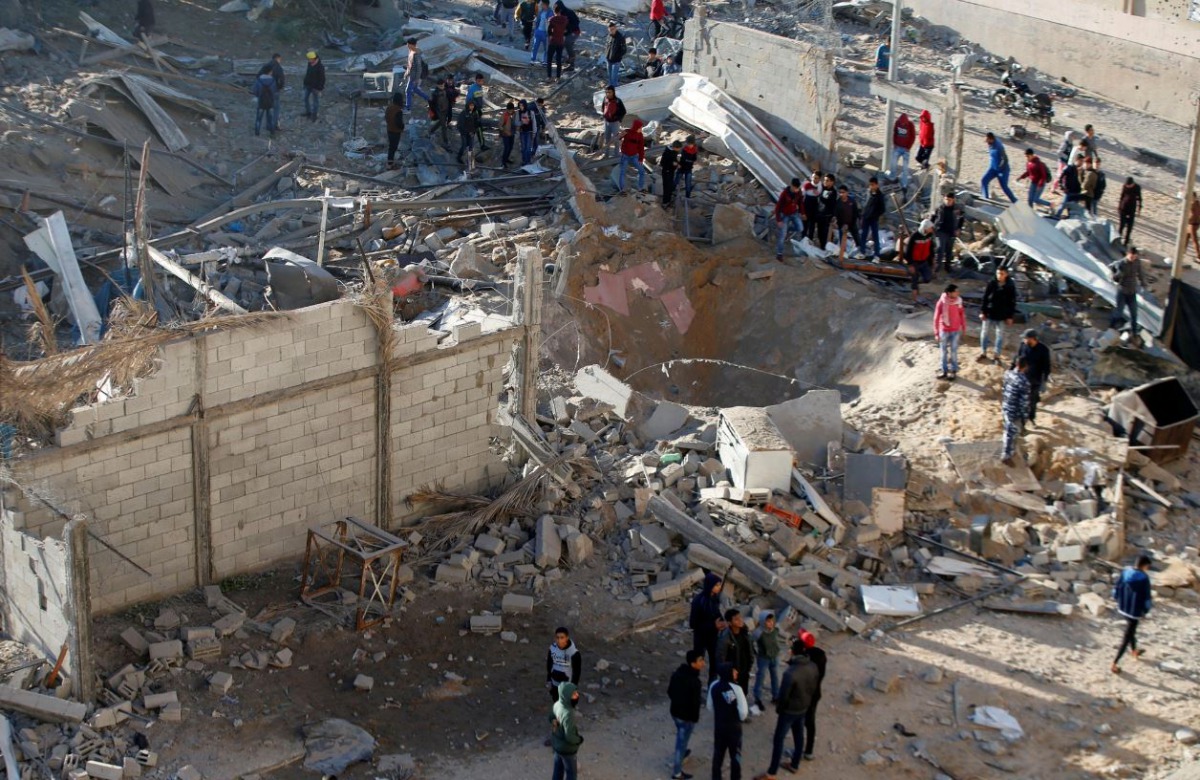 Palestinians gather around a militant target that was hit in an Israeli airstrike in the northern Gaza Strip December 9, 2017. REUTERS/Mohammed Salem