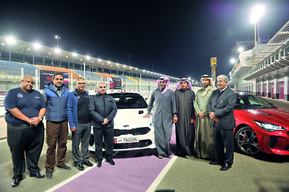 Abdulaziz Al Attiyah (centre), Chairman of Al Attiyah Motors and Trading and Nasser Salih Nasser Abdullah Al Attiyah, World Rally Champion, with other officials during KIA Stinger exclusive premiere at Lusail International Ciruit, yesterday. Pics: Baher A