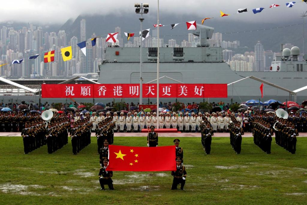 A file photo of People's Liberation Army Navy soldiers take part in a parade with a banner 