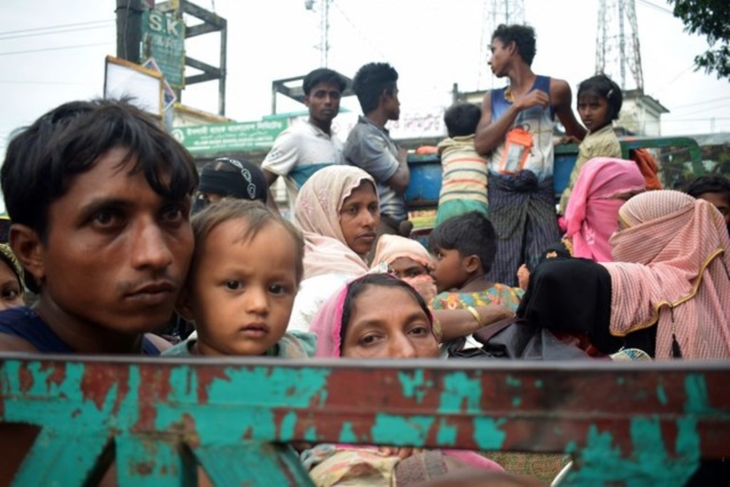 Rohingya refugees travel on an open-back truck on Teknaf-Cox's Bazar highway near Kutupalong refugee camp in Ukhiya, Bangladesh, on September 3, 2017. Photo by Jasmin Rumi/AFP.