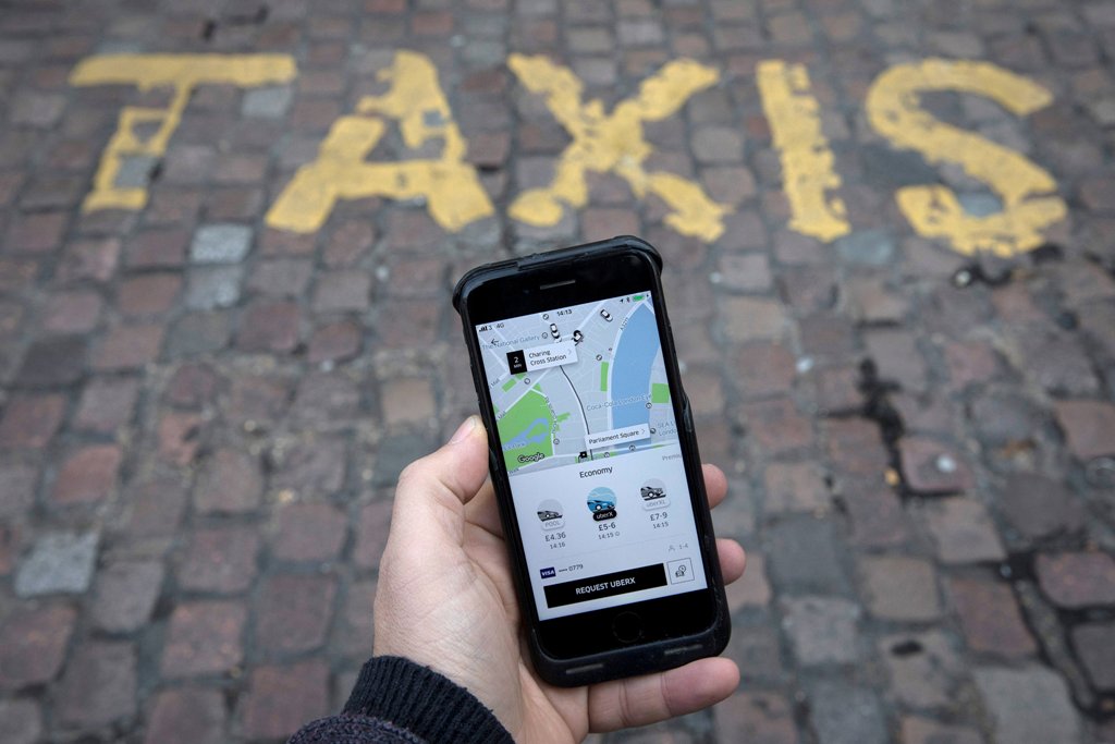 FILE PHOTO: A photo illustration shows the Uber app on a mobile telephone, as it is held up for a posed photograph, in London, Britain, November 10, 2017. REUTERS/Simon Dawson/File Photo
