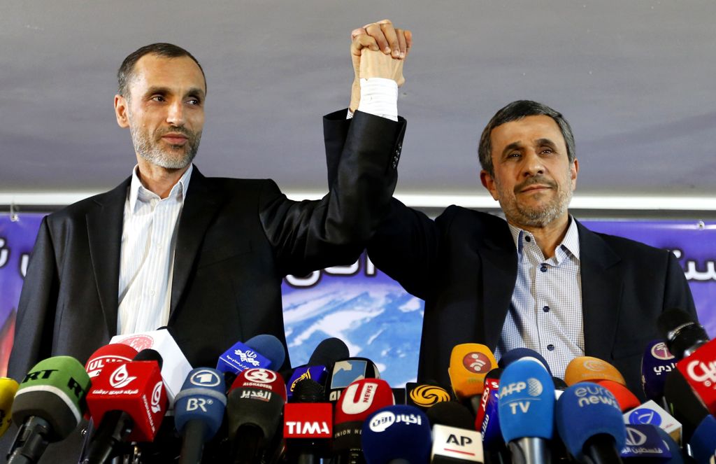 (FILES) This file photo taken on April 5, 2017 shows former Iranian president Mahmoud Ahmadinejad (R) and his former vice president, Hamid Baghaie, holding hands during a press conference in the capital Tehran. AFP / ATTA KENARE

