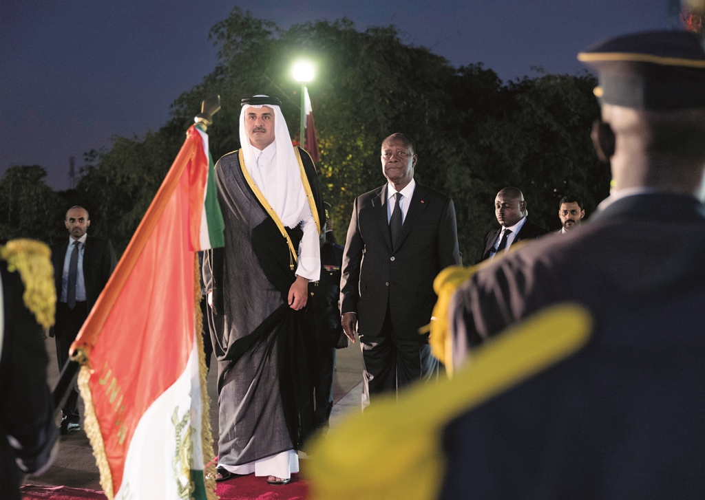 Emir H H Sheikh Tamim bin Hamad Al Thani receiving a guard of honour upon his arrival in Abidjan, Cote d’Ivoiree, yesterday. Also seen is Cote d’Ivoiree President Alassane Ouattara. 