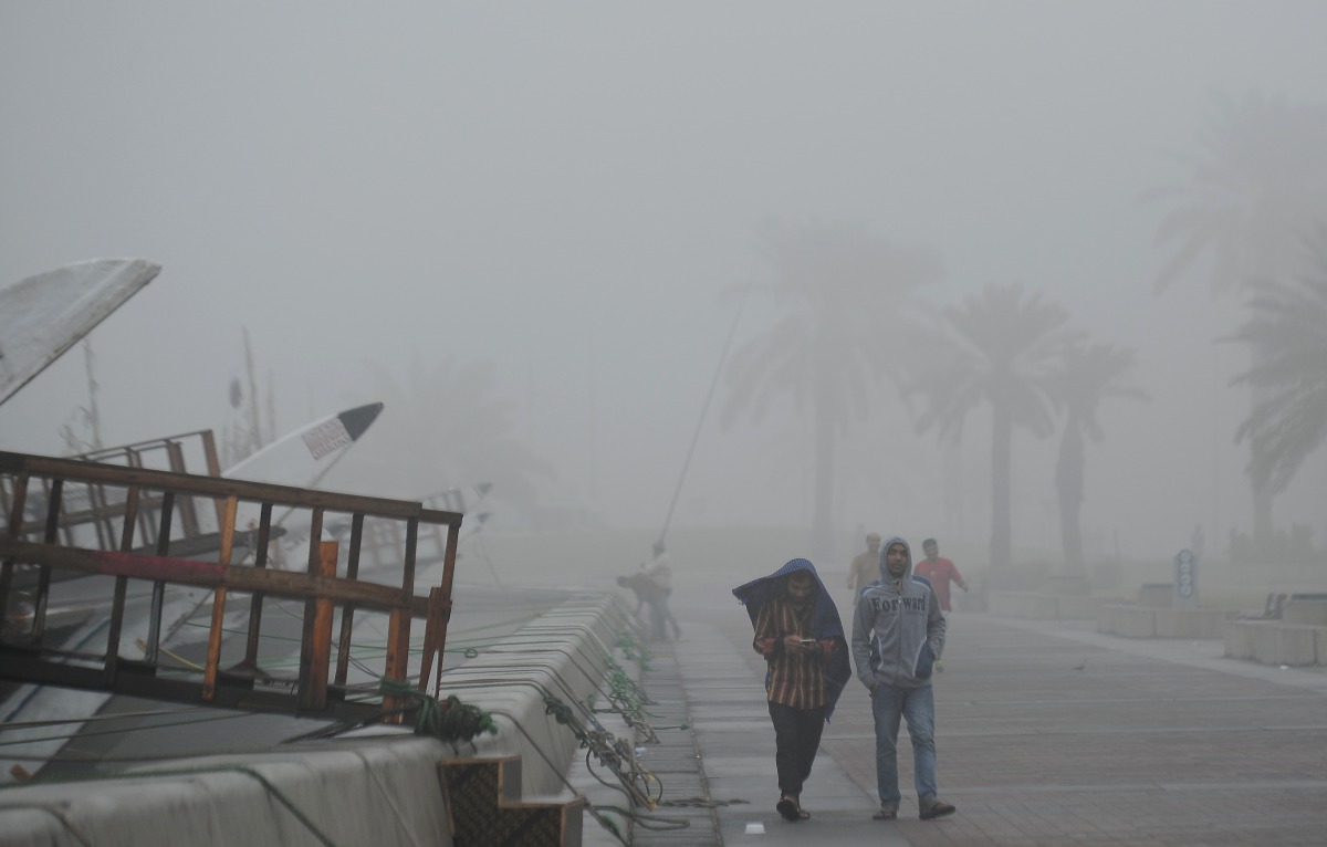People walk along the Corniche shrouded in thick fog yesterday morning. Qatar is likely to witness another foggy morning today according to the Meteorology Department. Pic: Salim Matramkot/The Peninsula
