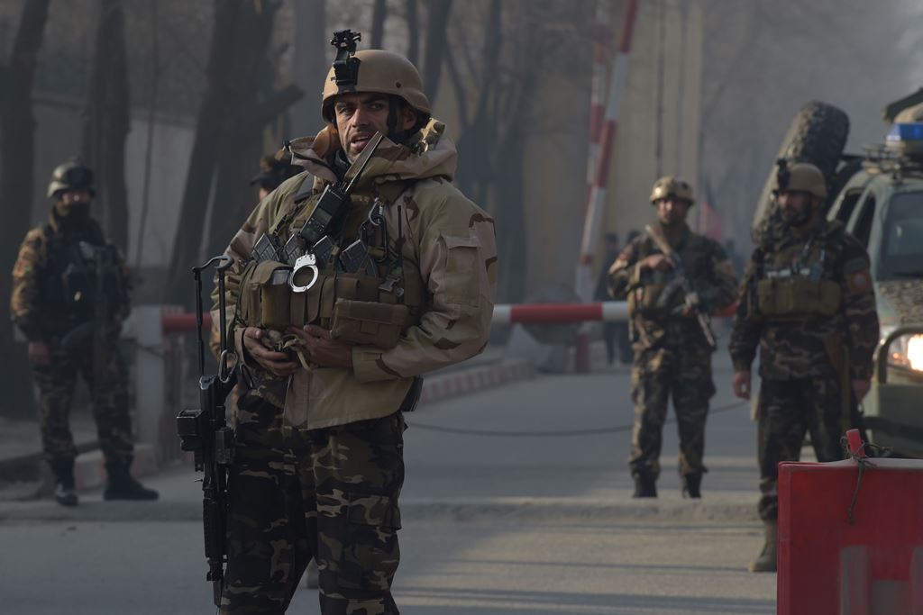Afghan security personnel keep watch near the site of a suicide attack in Kabul on December 25, 2017. AFP / Shah Marai 
