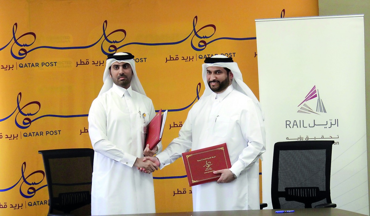 Qatar Post Chief Financial Officer Mohammed Jabr Al Naemi and Chief of Corporate Support, Khalifa Hassan Al Jehani, from Qatar Rail at the signing event.