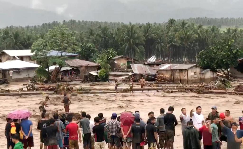 People attempt to rescue flood victims in Lanao Del Norte, Philippines, in this December 22, 2017 photo obtained from social media. Courtesy Aclimah Cabugatan Disumala via REUTERS.