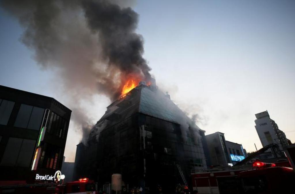File photo of a burning building seen as smoke arises from it in Jecheon, South Korea, December 21, 2017. Yonhap via REUTERS