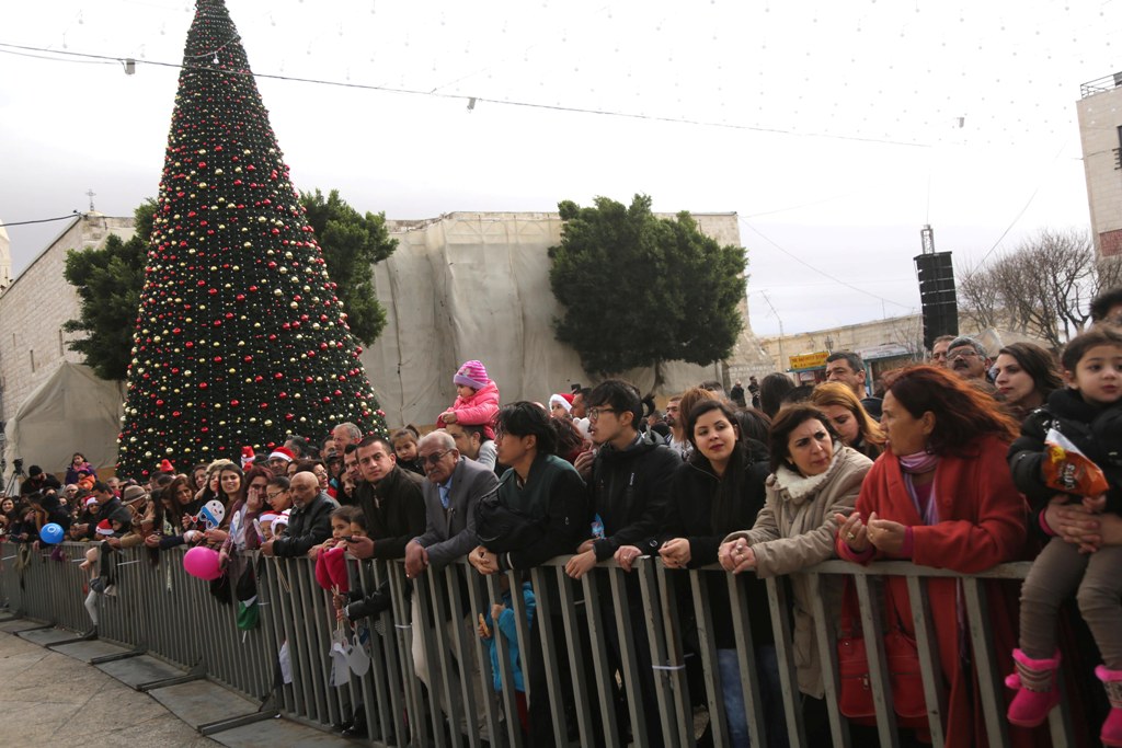 BETHLEHEM, WEST BANK - DECEMBER 24 : People gather within the 