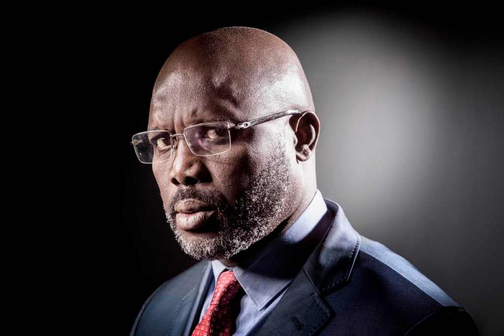 (FILES) This file photo taken on September 25, 2017, shows former football player and candidate in Liberia's presidential elections, George Weah as he poses during a photo session in Paris.   / AFP / JOEL SAGET