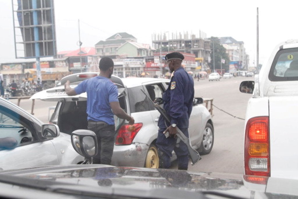 A security person checks a car in Kinshasa, Democratic Republic of Congo December 31, 2017. REUTERS/Kenny Katombe.