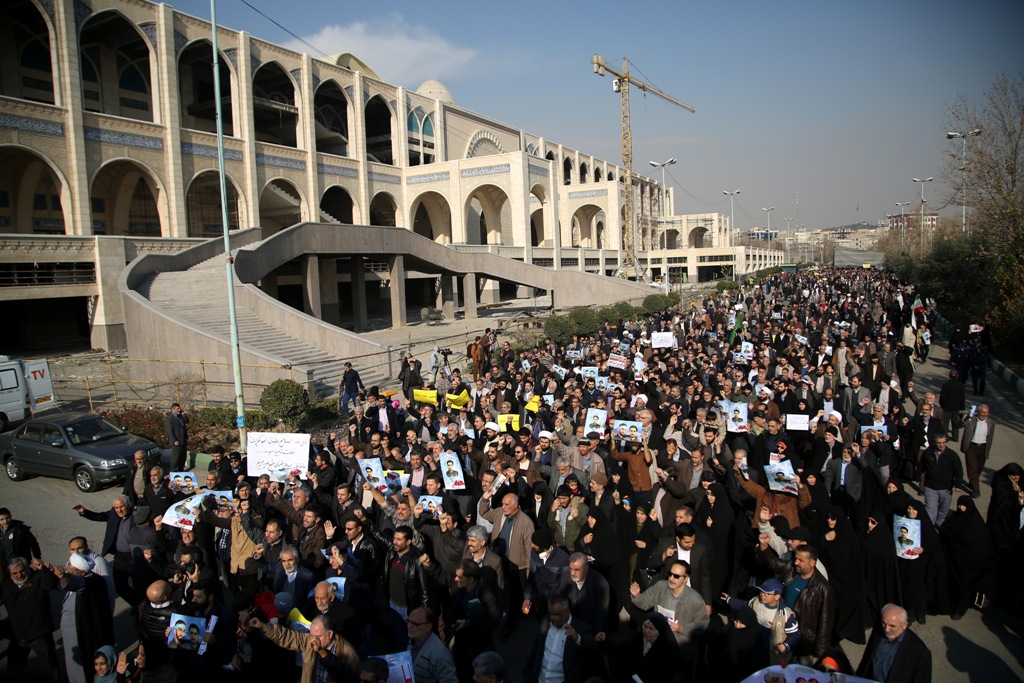Iranians hold placards during a protest after performing the Friday Prayer at Imam Khomeini Mosque following US' statement about backing the anti-government protests in Tehran, Iran on January 05, 2018. (Fatemeh Bahrami - Anadolu Agency).