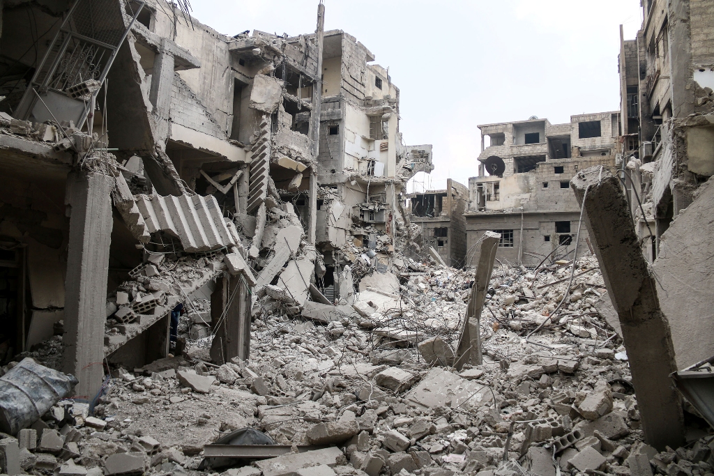Wreckages of collapsed buildings are seen after Assad Regime's airplanes carried out airstrike over the besieged town of Arbin in Eastern Ghouta in Damascus, Syria on January 4, 2018. Ammar Al Bushy - Anadolu
