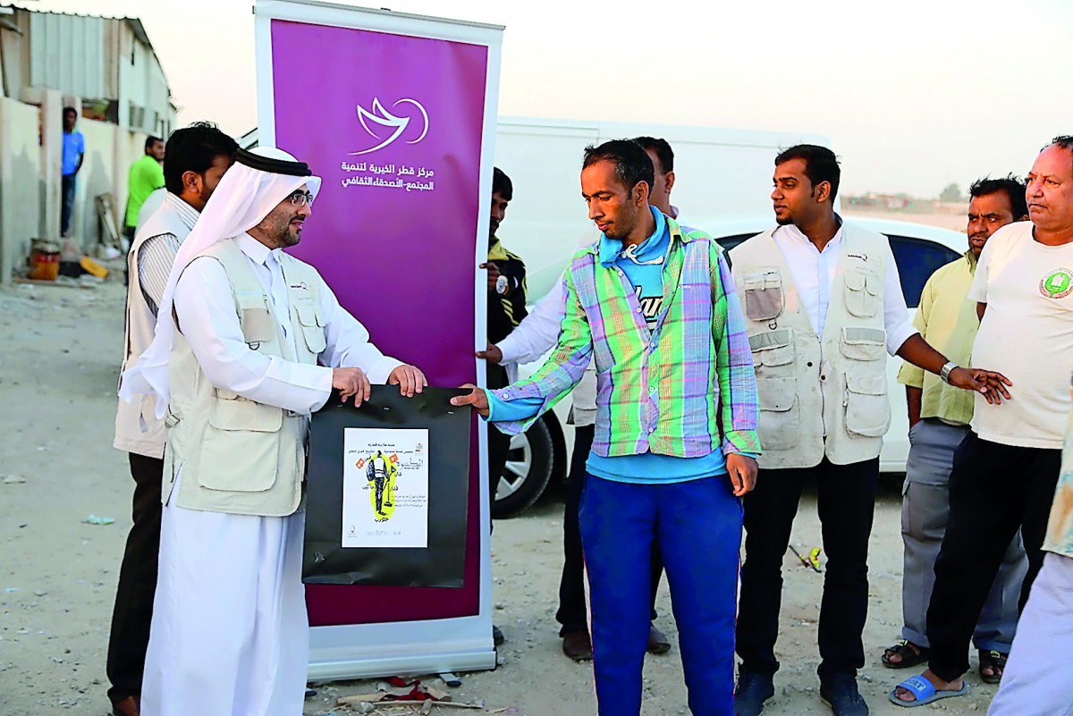 The students of Social Work course at Qatar University distributing winter-kits and other aid to workers under a Qatar Charity’s Local Winter Aids Programme. 
