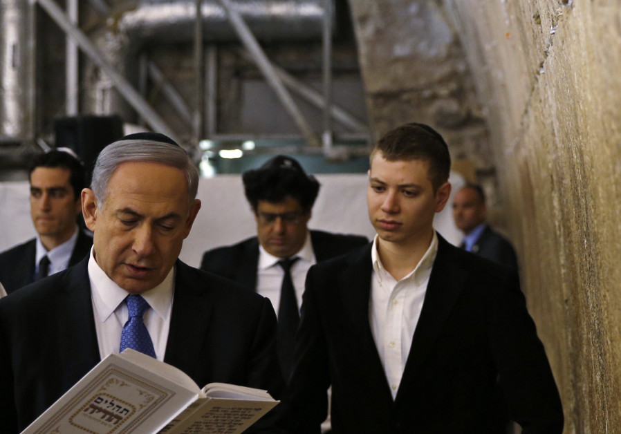 FILE PHOTO: Yair Netanyahu observes his father Israeli Prime Minister Benjamin Netanyahu reading a prayer at the Western Wall in Jerusalem's Old City (Ronen Zvulun / Reuters) 