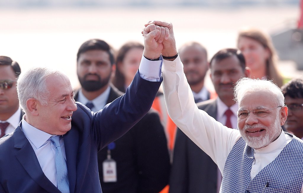 Israeli Prime Minister Benjamin Netanyahu and his Indian counterpart Narendra Modi raise their arms upon Netanyahu’s arrival at Air Force Station Palam in New Delhi, India, January 14, 2018. REUTERS/Adnan Abidi