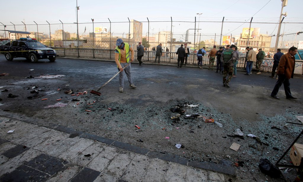 Iraqi security forces inspect the site of a bomb attack in Baghdad, Iraq January 15, 2018. REUTERS/Khalid al Mousily 
