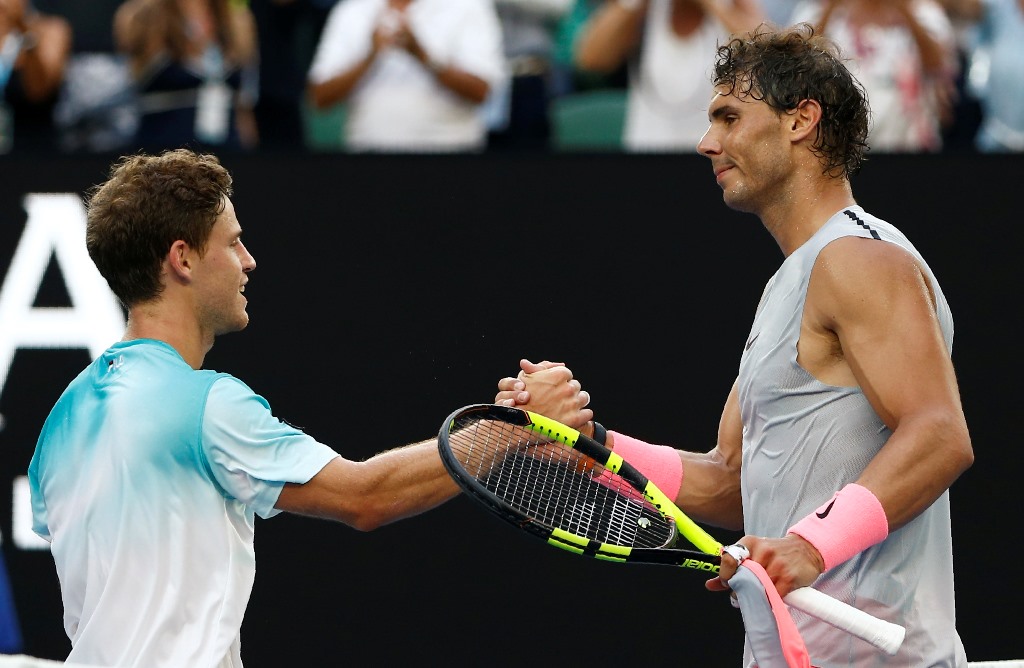 Rafael Nadal of Spain shakes hands with Diego Schwartzman of Argentina after Nadal won their match. REUTERS/Thomas Peter
