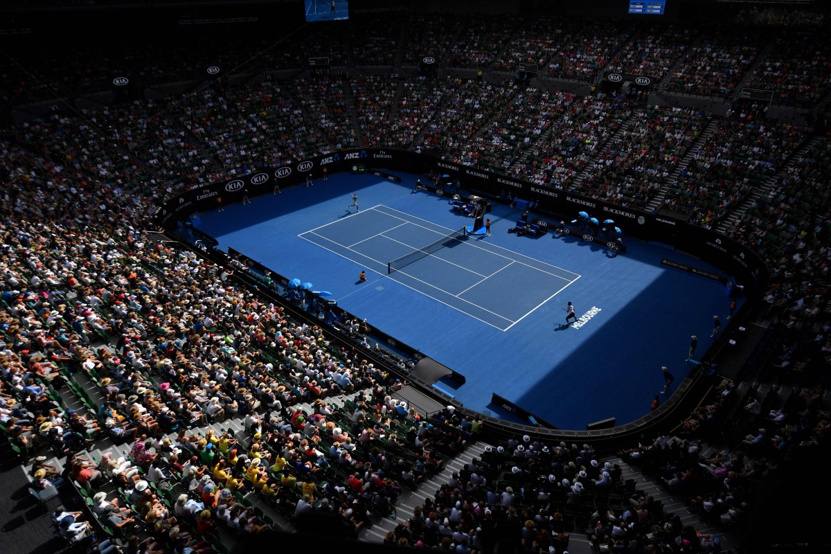 Spectators watch the men's singles match at the Australian Open tennis tournament in Melbourne. AFP / SAEED KHAN