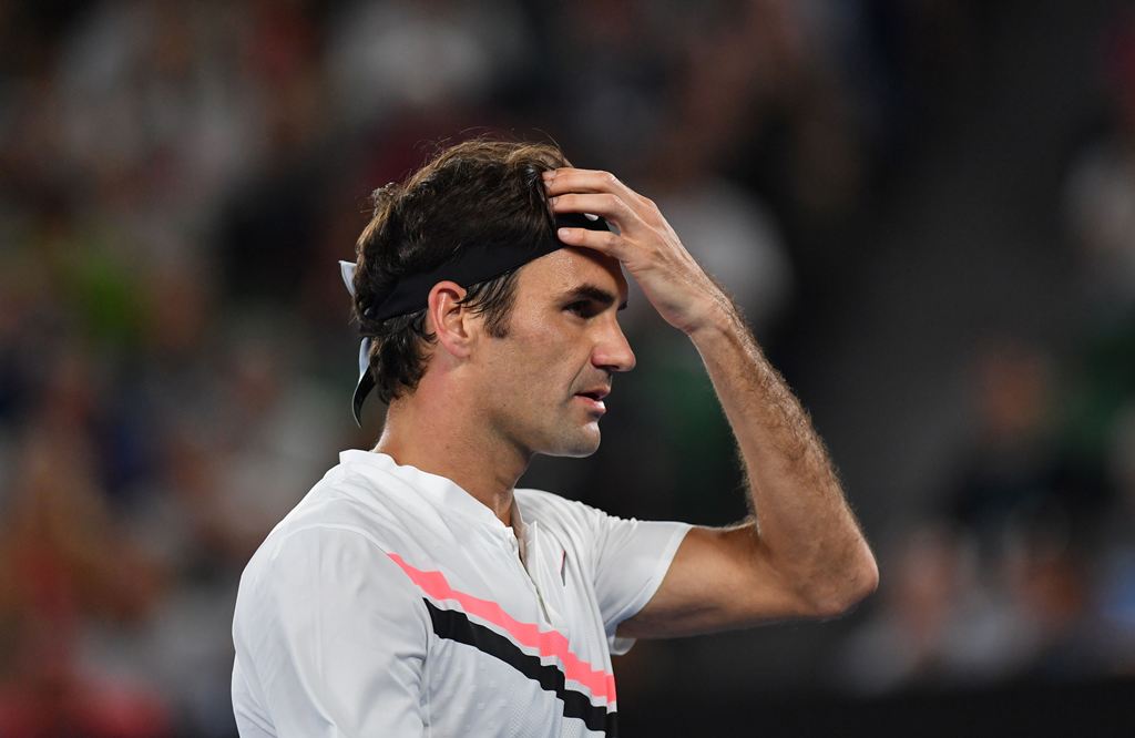Switzerland's Roger Federer gestures against Czech Republic's Tomas Berdych during their men's singles quarter-finals match on day 10 of the Australian Open tennis tournament in Melbourne on January 24, 2018. (AFP / SAEED KHAN)