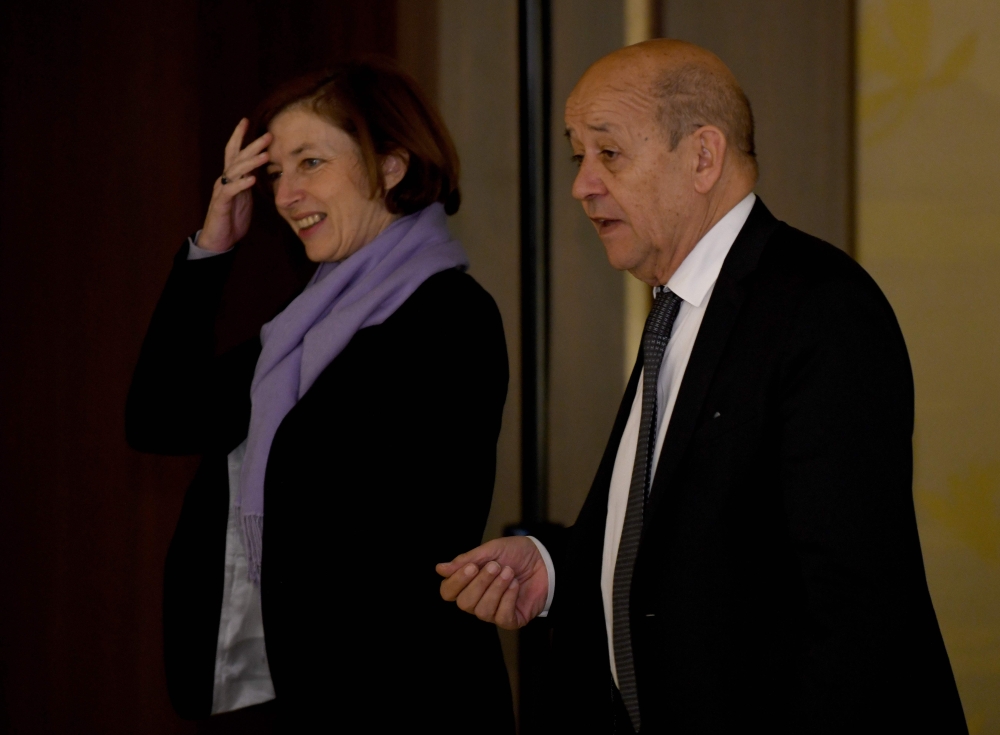 French Foreign Minister Jean-Yves Le Drian (R) chats with Defence Minister Florence Parly (L)  in Tokyo on January 26, 2018. / AFP / Toru YAMANAKA