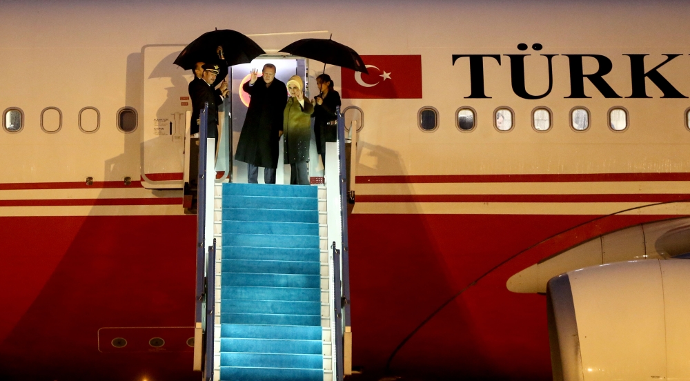 President of Turkey, Recep Tayyip Erdogan and his wife Emine Erdogan wave ahead of their departure for Italy at the Ataturk International Airport in Istanbul, Turkey on February 04, 2018. (Berk Özkan - Anadolu Agency)