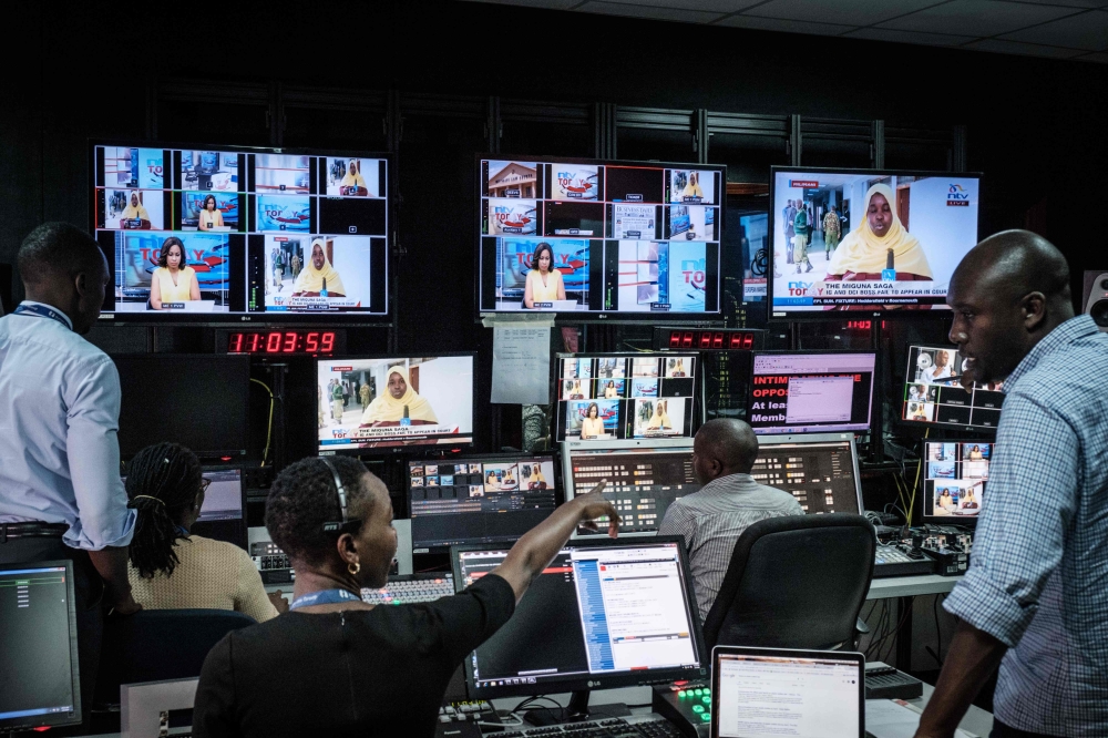 Staff work in a control during a news program at NTV studios in Nairobi on February 6, 2018. AFP / Yasuyoshi Chiba