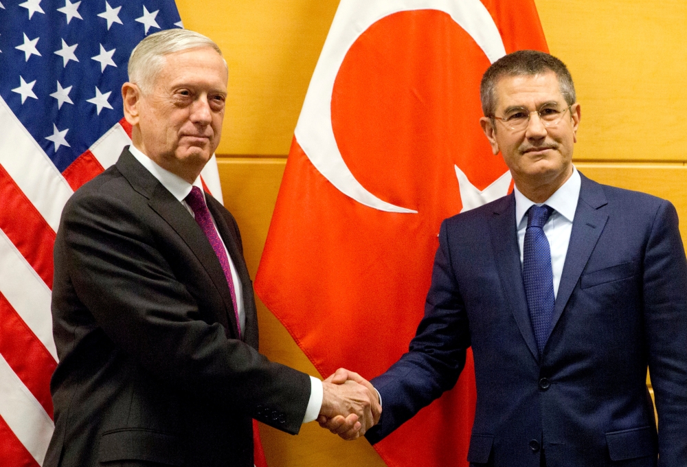 US Secretary of Defence Jim Mattis poses with Turkish Defence Minister Nurettin Canikli during NATO defence ministers meeting at the Alliance headquarters in Brussels, Belgium, February 14, 2018. REUTERS/Virginia Mayo/Pool