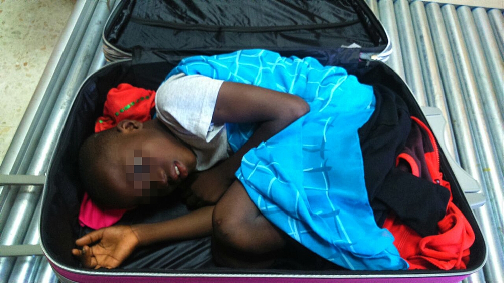 A handout file photo released by the Spanish Guardia Civil shows 8-year-old Ivorian boy Adou Ouattara hidden in a suitcase which was controlled in Ceuta, the Spanish enclave in the north of Morocco, May 08, 2015. AFP PHOTO/ HO/ SPANISH GUARDIA CIVIL
