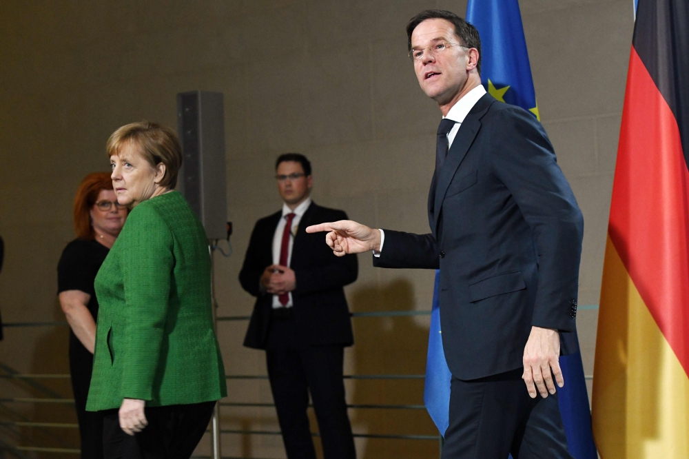 :German Chancellor Angela Merkel and Dutch Prime Minister Mark Rutte leave after a press statement on February 19, 2018 in Berlin. Germany OUT / AFP / dpa / Maurizio Gambarini
