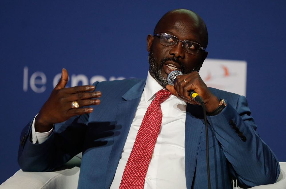Liberian President George Weah gestures as he speaks with students as he visits the Conservatoire des Arts et Métiers, in Paris on February 20, 2018. AFP / FRANCOIS GUILLOT