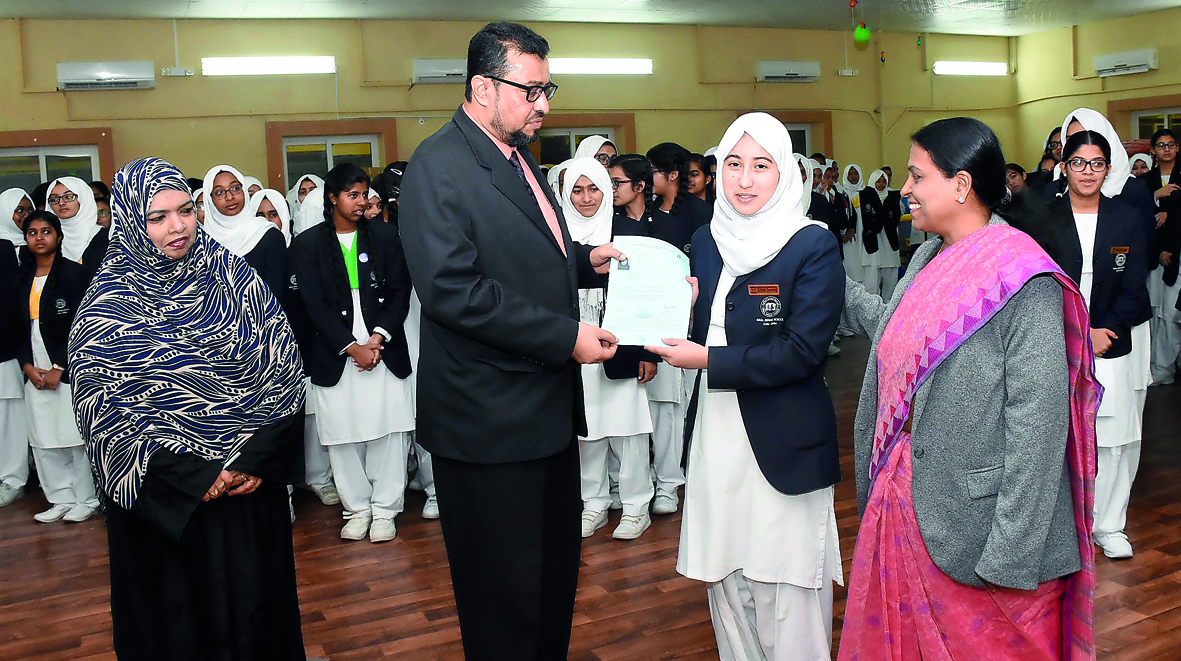 Ideal Indian School Principal Syed Shoukath Ali handing hall tickets to students. 