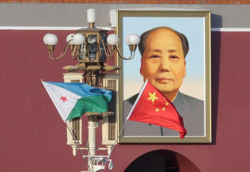 FILE PHOTO - Djibouti and Chinese national flags are seen in front of the portrait of China's late Chairman Mao Zedong at Tiananmen Square, ahead of a welcoming ceremony for Djibouti's President Ismail Omar Guelleh, in Beijing, China November 23, 2017. Re