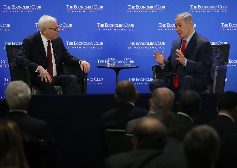 David Rubenstein, (L), president of the Economic Club of Washington, interviews Israeli Prime Minister Benjamin Netanyahu during a breakfast hosted by the Economic Club, on March 7, 2018 in Washington, DC. Mark Wilson/Getty Images/AFP