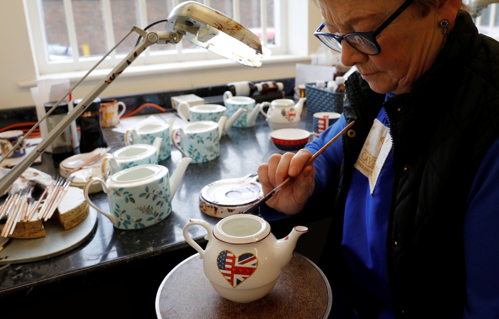 File photo of Sue Carter gilding a mug made to celebrate the Royal Wedding between Prince Harry and Meghan Markle at Halcyon Days' Caverswall factory in Stoke-on-Trent, Britain February 27, 2018. REUTERS/Darren Staples
