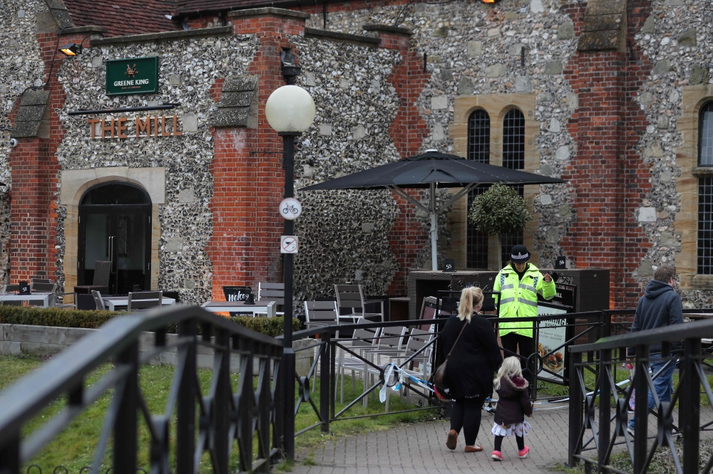A police officer stands in front of The Mill pub in Salisbury, southern England, on March 11, 2018, as investigations continue in connection with the major incident sparked after a man and a woman were apparently poisoned in a nerve agent attack a week ag