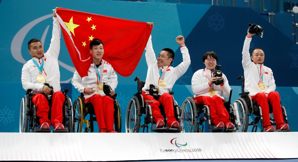 (L-R) Gold medallists Wang Haitao of China and his teammates Chen Jianxin, Liu Wei, Wang Meng and Zhang Qiang celebrate on the podium during the victory ceremony, Gangneung, South Korea, March 17, 2018. REUTERS/Carl Recine