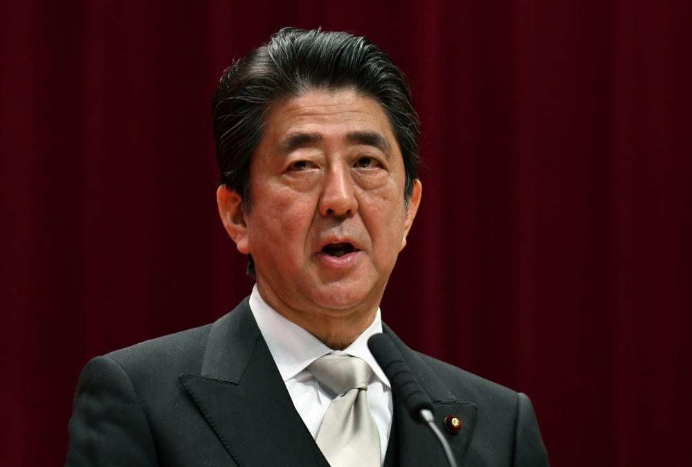 Japan's Prime Minister Shinzo Abe delivers a speech during the graduation ceremony for the National Defense Academy in Yokosuka, Kanagawa prefecture on March 18, 2018. AFP / Kazuhiro NOGI