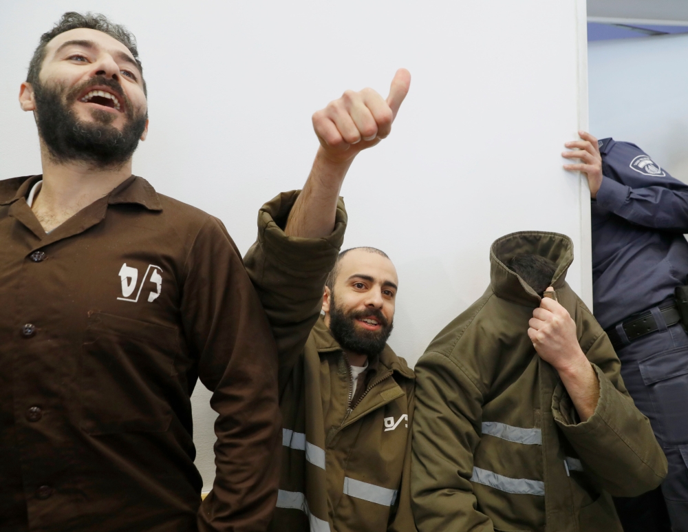French national Romain Franck (R), 24, a worker at the French consulate, and Palestinian Moufak al-Ajluni (L) and Mohamed Katout (C) appear in court the southern Israeli city of Beer Sheva on March 19, 2018, to face charges of smuggling guns from Gaza. AF
