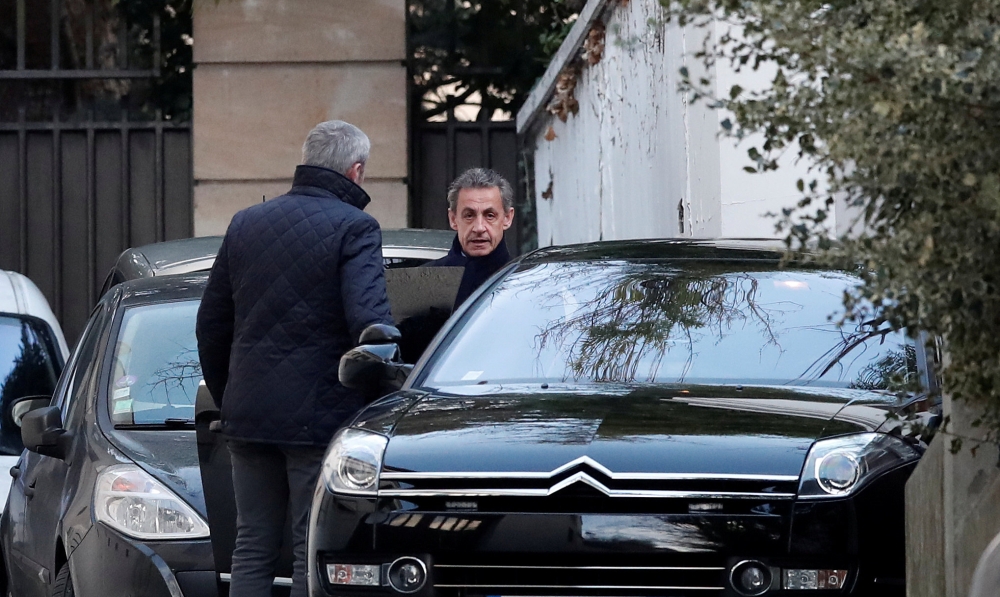 Former French President Nicolas Sarkozy enters his car as he leaves his house in Paris, France, March 21, 2018. REUTERS/Benoit Tessier