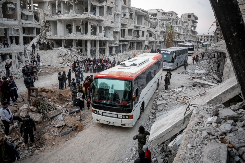A third convoy of vehicles carrying civilians from Eastern Goutha to Hama are seen in Damascus, Syria on March 24, 2018. ( Khaled Akasha - Anadolu Agency )
