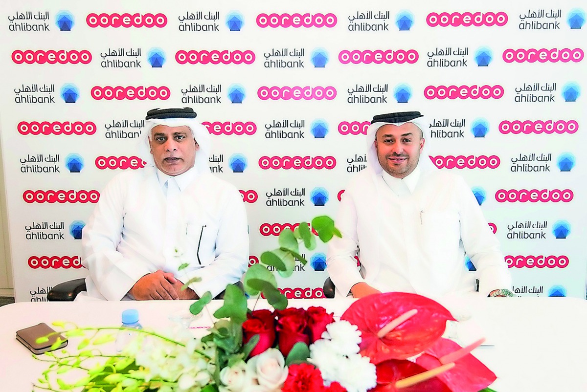 Officials of Ooredoo and Ahlibank at the agreement signing ceremony. 