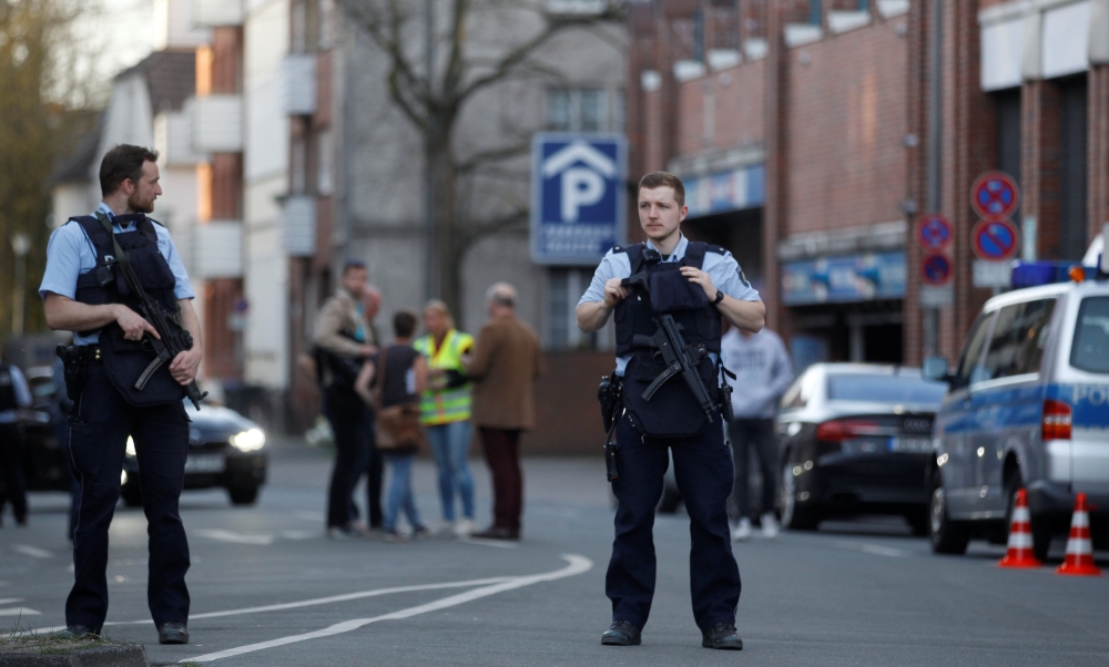 Police stands guard in a street near a place where a man drove a van into a group of people sitting outside a popular restaurant in the old city centre of Muenster, Germany, April 7, 2018. REUTERS/Leon Kuegeler